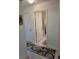 Hallway leading to a bathroom, and showing tile flooring and neutral wall paint at 1241 Denali Dr, Winter Haven, FL 33881