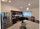 Modern kitchen featuring stainless steel appliances, granite countertops, and dark wood cabinets at 1241 Denali Dr, Winter Haven, FL 33881