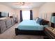 Spacious main bedroom with a neutral color scheme, large window, and carpeted floors at 1241 Denali Dr, Winter Haven, FL 33881