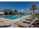 Community pool with lounge chairs, sunbathing deck and beautiful palms at 1241 Denali Dr, Winter Haven, FL 33881