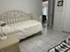 Neutral bedroom with tile flooring, a twin bed, and a view into the hallway at 133 Bianca Ct, Kissimmee, FL 34758