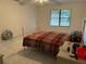 Simple bedroom with tile flooring, a window, and a fan at 133 Bianca Ct, Kissimmee, FL 34758