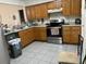 Functional kitchen with wooden cabinets, stainless steel appliances, and ample counter space at 133 Bianca Ct, Kissimmee, FL 34758