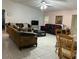 Comfortable living room featuring tile flooring, plush sofas, and a ceiling fan at 133 Bianca Ct, Kissimmee, FL 34758