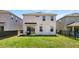 Well-maintained backyard with grass, black metal fence, grill, and patio at 1338 Riley Cir, Deland, FL 32724