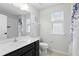 Well-lit bathroom with vanity, shower and tub, complete with a decorative shower curtain at 1338 Riley Cir, Deland, FL 32724