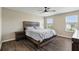 Cozy bedroom with wood floors, a decorative ceiling fan, and bright windows at 1338 Riley Cir, Deland, FL 32724