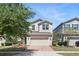 Inviting home featuring a two-car garage, lovely landscaping, and brick-paved driveway at 1338 Riley Cir, Deland, FL 32724