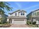 Charming two-story home featuring a brick driveway, a two-car garage, and a neatly landscaped front yard at 1338 Riley Cir, Deland, FL 32724