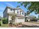 Charming home with a two-car garage, well-manicured landscaping, and a brick driveway at 1338 Riley Cir, Deland, FL 32724