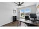 Bright home office featuring wood-look floors, ceiling fan and large windows providing natural light at 1338 Riley Cir, Deland, FL 32724