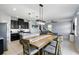 Modern kitchen with black cabinets, granite countertops, and stainless steel appliances at 1338 Riley Cir, Deland, FL 32724