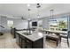 Open-concept kitchen featuring a granite island, stainless steel appliances, and a view into the living room at 1338 Riley Cir, Deland, FL 32724