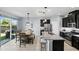 Modern kitchen with granite countertops, stainless steel appliances, and an adjacent dining area at 1338 Riley Cir, Deland, FL 32724