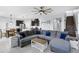 Open-concept living room featuring tile floors, a large sectional sofa, and seamless flow to the kitchen at 1338 Riley Cir, Deland, FL 32724