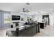 Bright living space featuring a modern media wall, tile flooring, and an open layout with the kitchen at 1338 Riley Cir, Deland, FL 32724