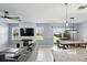 Bright, open-concept living space featuring tile flooring and a combined living, dining, and kitchen area at 1338 Riley Cir, Deland, FL 32724