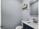 Cozy powder room with a stylish vanity, toilet, and decorative shelving at 13959 Marine Dr, Orlando, FL 32832
