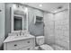 Modern bathroom featuring a sleek vanity, toilet, and glass-enclosed shower with marble-look tiles at 13959 Marine Dr, Orlando, FL 32832