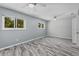 Bright bedroom featuring updated flooring, dual windows, and a ceiling fan at 13959 Marine Dr, Orlando, FL 32832