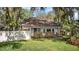 Home featuring a well-maintained lawn, charming front yard plants, and inviting curb appeal at 13959 Marine Dr, Orlando, FL 32832