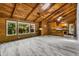 Spacious interior featuring wood-paneled walls, vaulted ceilings, and modern flooring at 13959 Marine Dr, Orlando, FL 32832