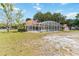 Backyard screened-in pool featuring a large enclosure, clean pool and landscaping at 1730 King Henry Dr, Kissimmee, FL 34744