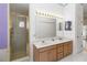 Bright bathroom featuring double sinks, shower and ample storage space at 1730 King Henry Dr, Kissimmee, FL 34744