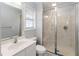 Modern bathroom featuring a walk-in shower with a glass enclosure, a vanity, and plenty of natural light at 1730 King Henry Dr, Kissimmee, FL 34744