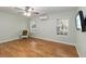 Comfortable bedroom with neutral walls, wood floors, a ceiling fan, and ample natural light from the windows at 1730 King Henry Dr, Kissimmee, FL 34744