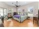 Comfortable bedroom with hardwood floors, ample natural light, and a ceiling fan at 1730 King Henry Dr, Kissimmee, FL 34744