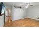Bright bedroom featuring wood floors, a closet, a ceiling fan, and easy access to the rest of the home at 1730 King Henry Dr, Kissimmee, FL 34744