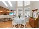 Open-concept dining area featuring lots of windows, hardwood floors, and views to the outdoor pool at 1730 King Henry Dr, Kissimmee, FL 34744