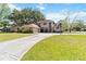 Two-story home with a long driveway, a basketball hoop, and well-maintained front lawn at 1730 King Henry Dr, Kissimmee, FL 34744