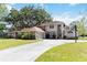 Two-story home with a long driveway, a basketball hoop, and well-maintained front lawn at 1730 King Henry Dr, Kissimmee, FL 34744