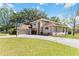 Two-story home with a long driveway, a basketball hoop, and well-maintained front lawn at 1730 King Henry Dr, Kissimmee, FL 34744