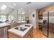 Open-concept kitchen with an island cooktop and stainless-steel appliances at 1730 King Henry Dr, Kissimmee, FL 34744