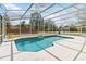 Screened-in pool with tile accents and ample deck space for lounging and entertaining at 1730 King Henry Dr, Kissimmee, FL 34744