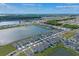 A high angle view showcasing modern homes in a residential community situated around a shimmering lake at 1774 Walnut Creek Dr, Kissimmee, FL 34744