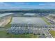A high angle view of a residential community situated around a shimmering lake, showcasing modern homes and landscaping at 1774 Walnut Creek Dr, Kissimmee, FL 34744