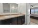 Bathroom featuring double sinks, dark cabinets, tan countertops, and shower with curtain at 1774 Walnut Creek Dr, Kissimmee, FL 34744