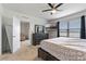 Comfortable bedroom boasts a large window, ceiling fan, and dark wood dresser at 1774 Walnut Creek Dr, Kissimmee, FL 34744