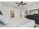Bright bedroom features a ceiling fan, large dresser, and access to the ensuite bathroom at 1774 Walnut Creek Dr, Kissimmee, FL 34744