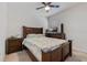 Bedroom with dark wood furniture, a patterned comforter, a ceiling fan, and bright natural light at 1774 Walnut Creek Dr, Kissimmee, FL 34744
