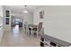 Dining table with seating for six, leading to the living area and an entryway bench at 1774 Walnut Creek Dr, Kissimmee, FL 34744