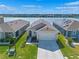 Inviting single-story home with a well-manicured lawn, a two-car garage, and a picturesque lake view at 1774 Walnut Creek Dr, Kissimmee, FL 34744