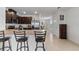 Kitchen featuring bar seating, stainless appliances, and brown cabinetry with modern hardware at 1774 Walnut Creek Dr, Kissimmee, FL 34744