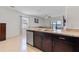 Open-concept kitchen with stainless steel appliances, granite countertops, and a view of the living area at 1774 Walnut Creek Dr, Kissimmee, FL 34744
