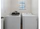 Bright laundry room equipped with a washing machine and dryer, and white walls at 1774 Walnut Creek Dr, Kissimmee, FL 34744