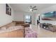 Comfortable living room with tile floors, a ceiling fan, a TV, and sliding doors to the outdoor space at 1774 Walnut Creek Dr, Kissimmee, FL 34744